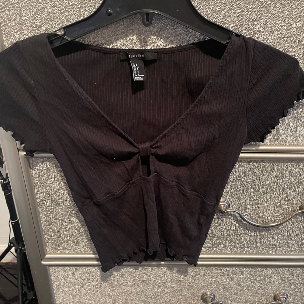 Black cropped ruffled top with tiny hole in the middle